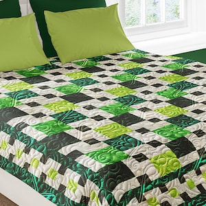 May include: A green and black checkered quilt with a floral pattern. The quilt is made of soft, quilted fabric and is perfect for adding a touch of elegance to any bedroom.