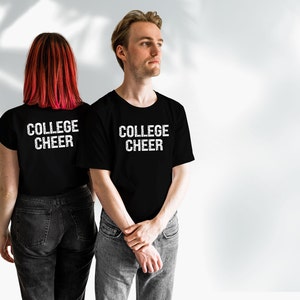 May include: Two people wearing black t-shirts with the text "COLLEGE CHEER" printed in white. The shirts are a matching set.