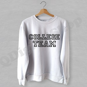May include: White sweatshirt with a black distressed graphic that says "COLLEGE TEAM".