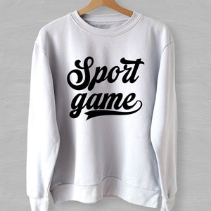 May include: White sweatshirt with black text that reads "Sport game" in a retro font.