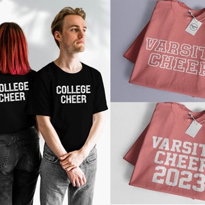 May include: Two black t-shirts with white text that says "College Cheer". Two pink t-shirts with white text that says "Varsity Cheer" and "Varsity Cheer 2023".