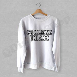 May include: White sweatshirt with black text that reads "COLLEGE TEAM" in a vintage style font.