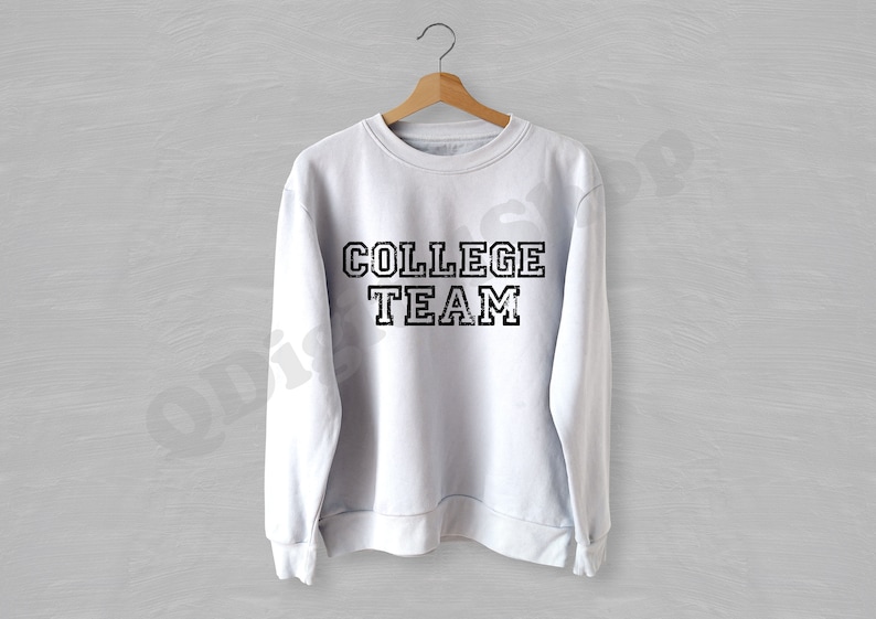 May include: White sweatshirt with black text that reads "COLLEGE TEAM" in a vintage style font.