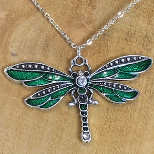 This beautifully styled Dragonfly pendant is crafted with two Glass crystal Stone beautiful emeraled green colour on the wings.