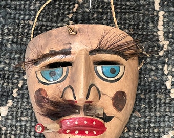 Early Mexican dance mask with horse hair eye lashes and mustache .  Bright colors, vintage hand carved, wood and hand painted.