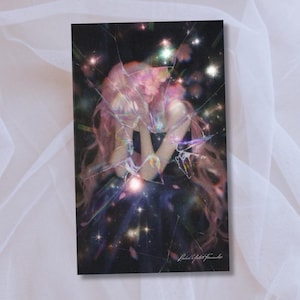 May include: A rectangular art print featuring a digital illustration of a person with long pink hair, set against a dark, starry background. The image has a cracked glass effect overlay. The artist's signature is in the bottom right corner.