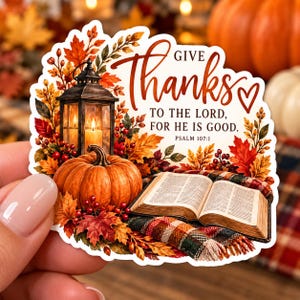 May include: A die-cut sticker featuring a lit lantern, an orange pumpkin, and an open book on a plaid blanket, surrounded by autumn leaves. The text reads: GIVE Thanks TO THE LORD, FOR HE IS GOOD. PSALM 107:1, with a small heart icon included.