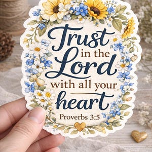 May include: A floral sticker with the text "Trust in the Lord with all your heart" from Proverbs 3:5. The design features a border of yellow sunflowers, blue and white flowers, and green leaves. A small gold heart is at the bottom.
