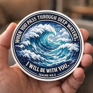 May include: A white ceramic mug with a black handle and the text "But First, Coffee" in a black, bold font. The mug is on a white surface.