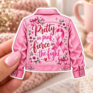 May include: A pink denim jacket sticker featuring the text Pretty in pink, fierce in the fight, decorated with a pink awareness ribbon, floral illustrations, and small bows. The design includes metallic buttons on the cuffs and hem.
