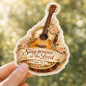 May include: A sticker featuring a detailed acoustic guitar design with a floral border and the text "Sing praises to the Lord" and "Psalm 92:1". The guitar is brown and cream-colored, with a decorative banner.