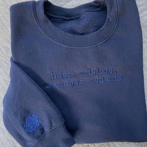 Schitt&#39;s Creek quote &quot;best wishes, warmest regards&quot;  embroidered on a sweatshirt with a monochrome design, unique with a rose on sleeve cuff