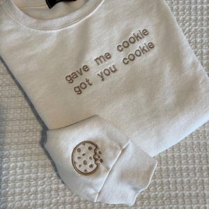 New Girl quote &quot;gave me cookie got you cookie&quot; embroidered on a comfy sweatshirt, unique with a cookie added to the sleeve
