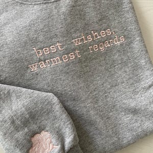 Schitt&#39;s Creek quote &quot;best wishes, warmest regards&quot;  embroidered on a sweatshirt in a minimalistic design, unique with a rose on the sleeve
