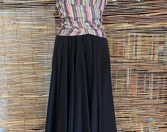 May include: A black maxi skirt with a striped halter top. The top has a V-neck and is made of a lightweight fabric.