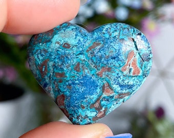 May include: A heart-shaped turquoise and copper gemstone with a mottled pattern.
