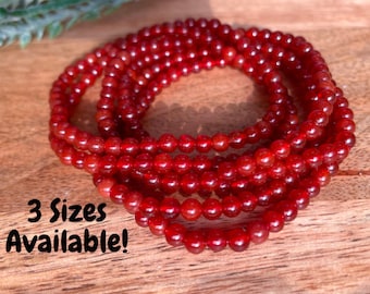 May include: Red carnelian bead bracelets in three sizes. The bracelets are made of small, round beads and are stacked on top of each other. 3 Sizes Available!