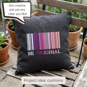 May include: A square charcoal gray cushion featuring an embroidered barcode design in shades of white, purple, and pink. Below the barcode, the text reads BE ORIGINAL in white and pink. A speech bubble above says Get creative and use any color you like!