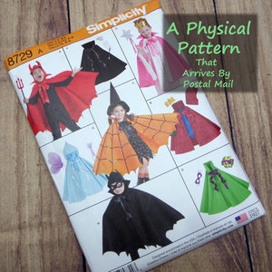 May include: A Simplicity 8729 sewing pattern envelope featuring illustrations of various capes and costumes including a red devil cape, a pink princess cape, an orange spiderweb cape, a blue hooded cape, and a green cape with a purple ribbon.
