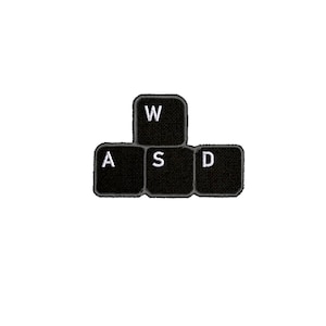 May include: Black keyboard keys with white lettering spelling out "WASD".