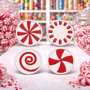May include: Four round, white and red peppermint candy-themed embroidered patches with different designs. Two glass jars filled with red and white striped candies are in the background. The patches have a white border.