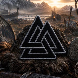 May include: A black and gray embroidered patch featuring the Valknut symbol, a design of three interlocking triangles. The patch is displayed on a rock with a fur-like texture, with a Viking-themed background including a longboat and mountains.