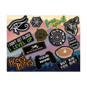 May include: A collection of embroidered patches with various designs and text. Patches include a wolf howling, a spiderweb, an eye, a pie, and phrases like "I don't get older I level up" and "Hocus Pocus".