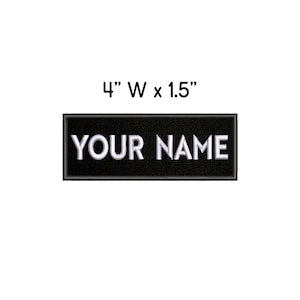 May include: Black rectangular patch with white embroidered text that reads "YOUR NAME". The patch measures 4 inches wide by 1.5 inches tall.