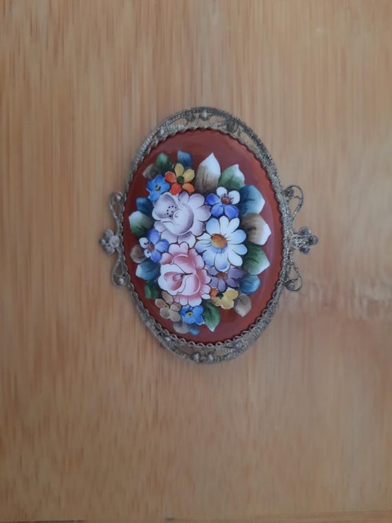 Vintage Hand-Painted Floral Porcelain Brooch with Ornate Filigree Frame