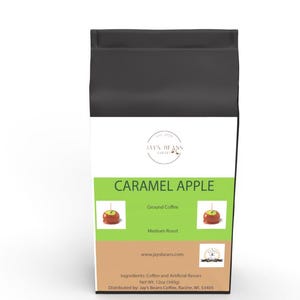 May include: A black bag of ground coffee with a caramel apple design. The bag is labeled "Caramel Apple" and "Jay's Beans Coffee". The bag is 12 oz (340g).