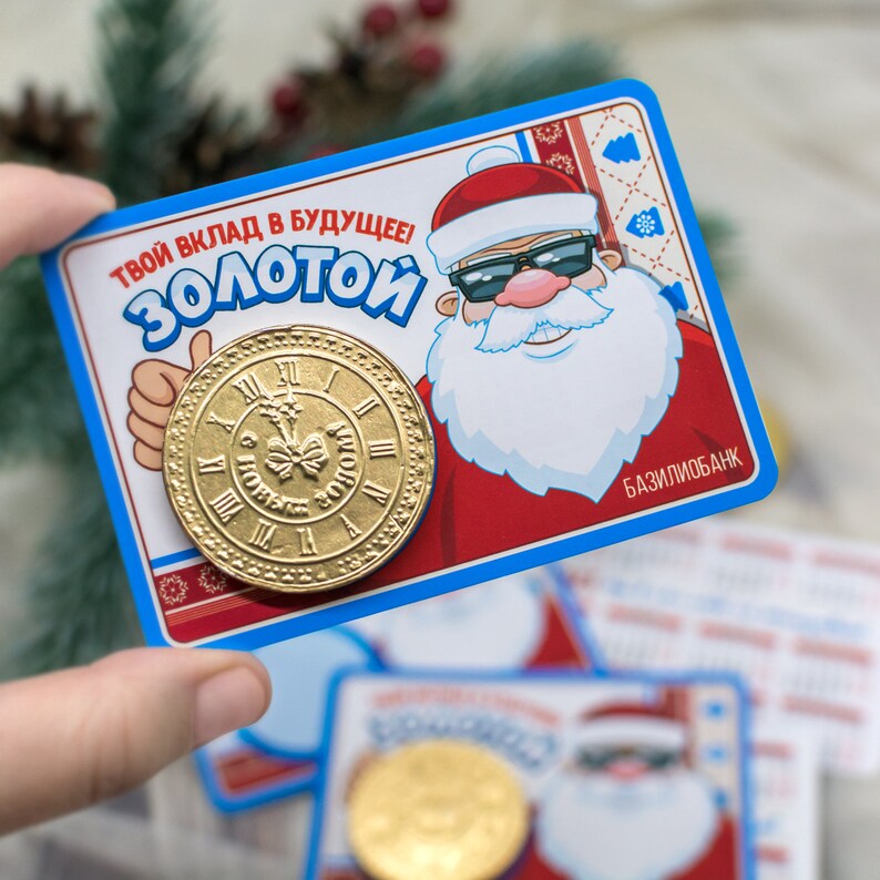 Puede incluir: Una tarjeta azul y roja con un Pap&aacute; Noel de dibujos animados que lleva gafas de sol. La tarjeta dice "&iexcl;Tu contribuci&oacute;n al futuro! Dorado" y presenta una moneda de oro con una esfera de reloj. La tarjeta tambi&eacute;n dice "Baziliobank" en la esquina inferior derecha.