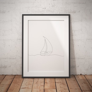 May include: A black framed print with a simple line drawing of a sailboat on a white background.