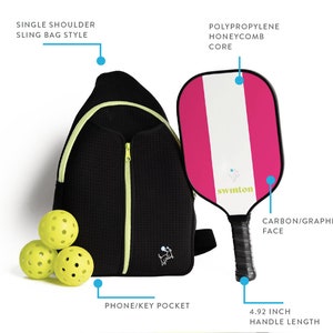 May include: A black sling bag with a neon green zipper and a small embroidered logo. The bag has a single shoulder strap and a phone/key pocket. A pink and white pickleball paddle with a black handle and the word "swinton" printed on it. Three yellow pickleballs are in the lower left corner of the image. The paddle has a 4.92 inch handle length.