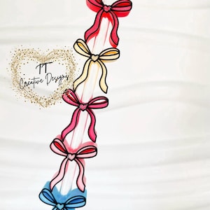 May include: A clear straw decorated with colorful bows. The bows are in shades of red, pink, yellow, and blue, each outlined in black. The bows are arranged vertically along the straw.