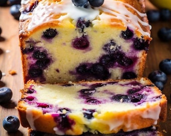 May include: A loaf of blueberry lemon bread with a lemon slice on top and a white glaze. The bread is sliced and stacked on a wooden surface with blueberries scattered around.