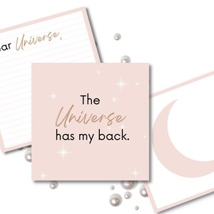 May include: Three pink cards with a white crescent moon on one, a pink background with gold stars and the text "The Universe has my back." on another, and a lined card with the text "Dear Universe," on the third.