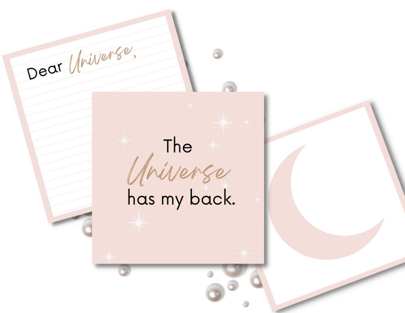 May include: Three pink cards with a white crescent moon on one, a pink background with gold stars and the text "The Universe has my back." on another, and a lined card with the text "Dear Universe," on the third.