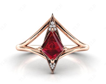 May include: A rose gold ring with a ruby gemstone set in a geometric, pointed design. The ruby is surrounded by smaller diamonds.