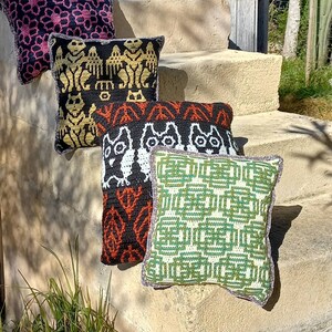 Sample of cushions made with patterns of Rural Crafts. Gargoyle, patterned flowers, celtic and owl.
