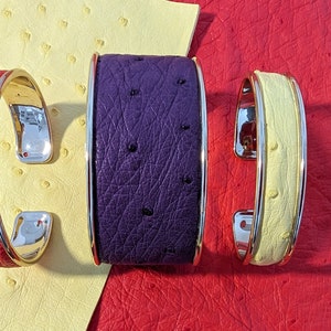 Rigid cuff bracelets in golden brass covered with colored leather