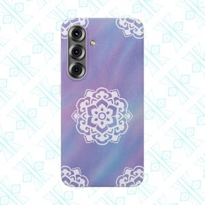 May include: A phone case with a purple and blue galaxy design and a white floral mandala in the center. The case has a camera cutout and white floral corner accents. The case is designed for a smartphone.