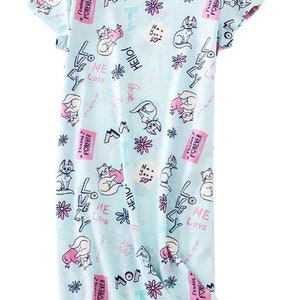 May include: Light blue short-sleeve nightgown with a repeating pattern of cartoon cats, flowers, and text. The text includes words like "Love", "Hello", and "Forever". The nightgown has a scoop neck and a relaxed fit.