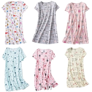 May include: Six short-sleeved nightgowns in various colors and patterns. The patterns include cartoon characters, coffee cups, sheep, celestial designs, and text. The nightgowns are displayed on a white background.