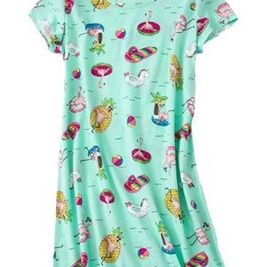May include: A light green nightgown with a scoop neck and short sleeves. The fabric is patterned with colorful illustrations of flamingos, pineapples, beach balls, and other summer-themed images. The nightgown is a knee-length style.