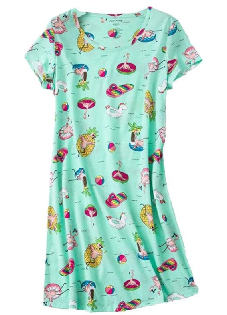 May include: A light green nightgown with a scoop neck and short sleeves. The fabric is patterned with colorful illustrations of flamingos, pineapples, beach balls, and other summer-themed images. The nightgown is a knee-length style.