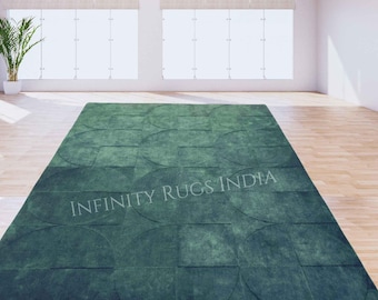 May include: A green area rug with a geometric pattern of overlapping circles and squares. The rug has a textured, distressed look and the text "INFINITY RUGS INDIA" is printed in the center.