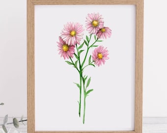 May include: A framed watercolor print featuring a cluster of pink flowers with yellow centers and green stems. The artwork is set against a white background and framed in a light brown wooden frame. The floral art print is a botanical illustration.