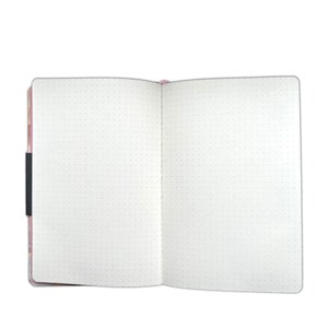 May include: Open, dot grid notebook with a pink floral cover and a black elastic closure. The pages are white with evenly spaced gray dots, perfect for journaling, sketching, or note-taking. The notebook is open, displaying the blank pages.