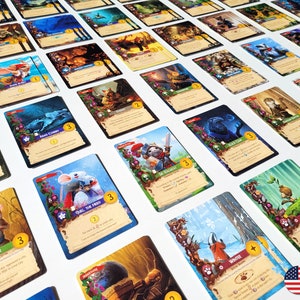 May include: A collection of illustrated fantasy game cards featuring various animal characters and thematic elements. The cards display vibrant colors, including blues, greens, and browns, with text and numerical values. The cards are arranged on a white surface.