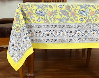 May include: Yellow tablecloth with a floral pattern and a blue and brown border. The tablecloth is made of cotton and is ideal for a dining table.